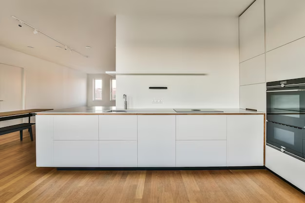 hardwood floor in kitchen with white cabinets